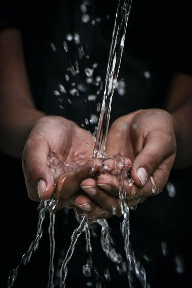 Clean Water Flowing Through Hands